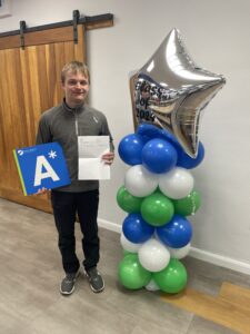 Boy receiving exam results A-level maths