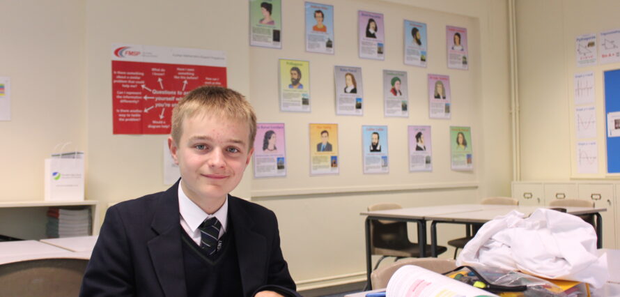 Boy studying Mathematics in classroom